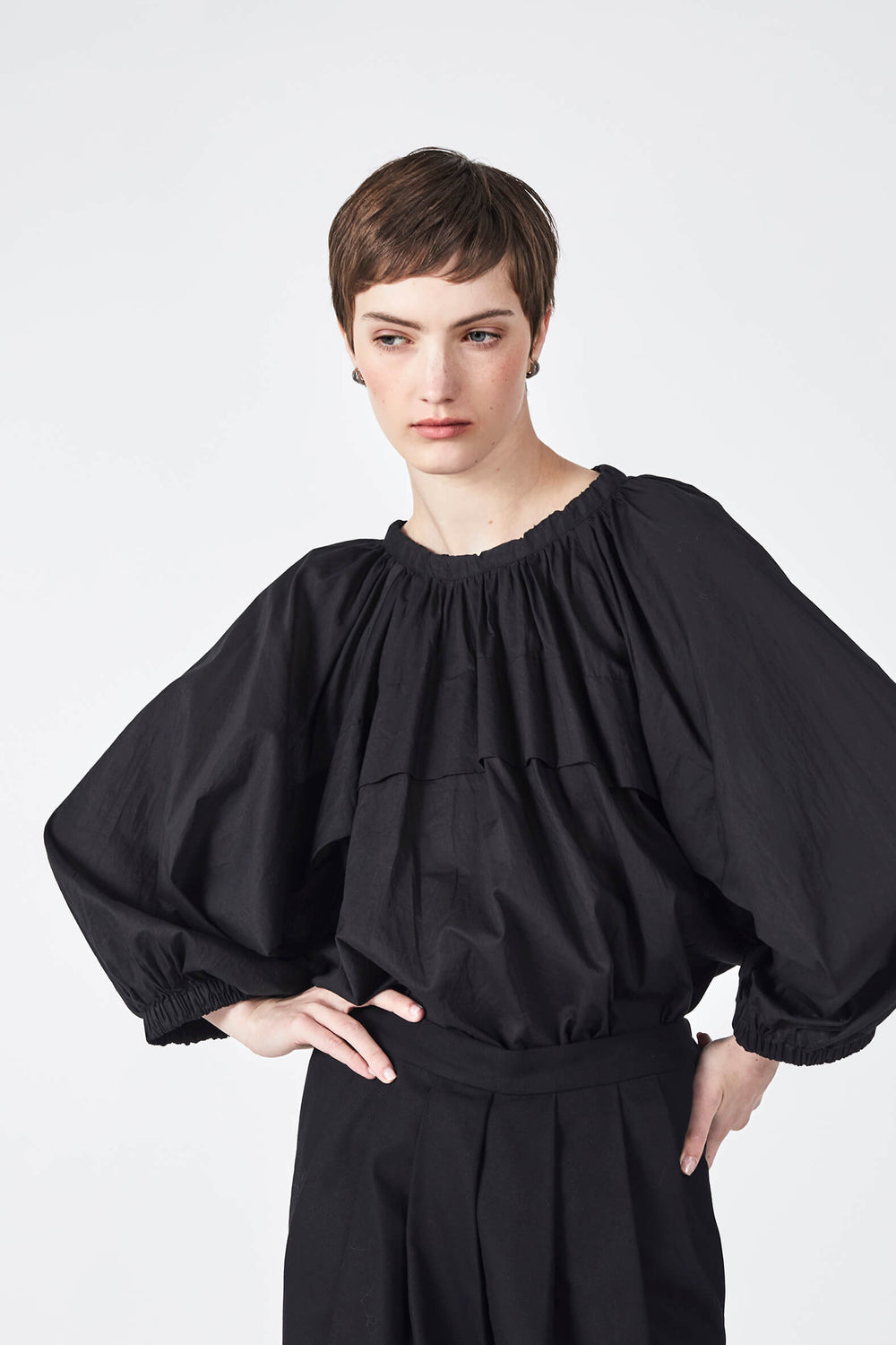 woman wearing a romantic, feminine,  lilac, handmade, gathered frilled, puffed sleeve, pussy bow cotton top