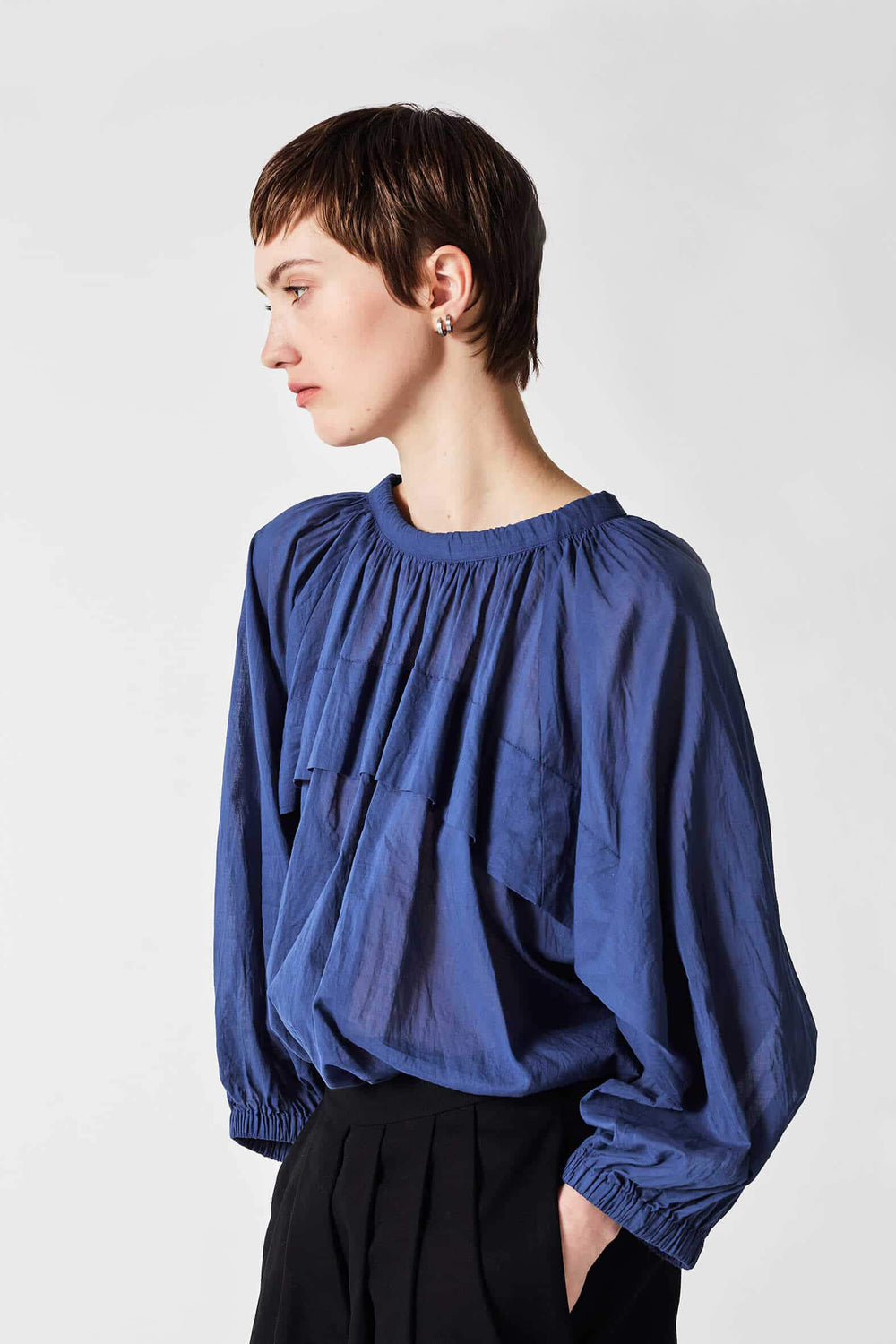 woman wearing a romantic, feminine,  blue, handmade, gathered frilled, puffed sleeve, pussy bow cotton top