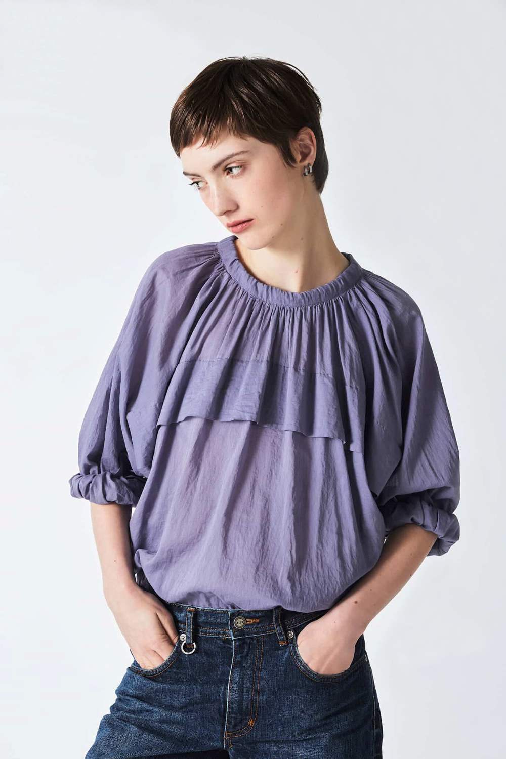 woman wearing a romantic, feminine,  lilac, handmade, gathered frilled, puffed sleeve, pussy bow cotton top