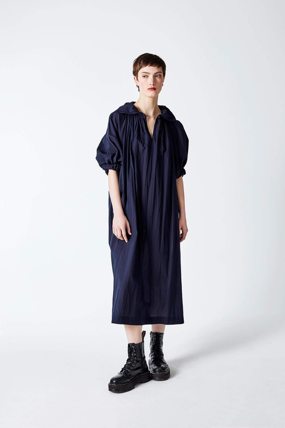 woman wearing a romantic, feminine,  navy, handmade, gathered , frilled, puffed sleeve maxi dress