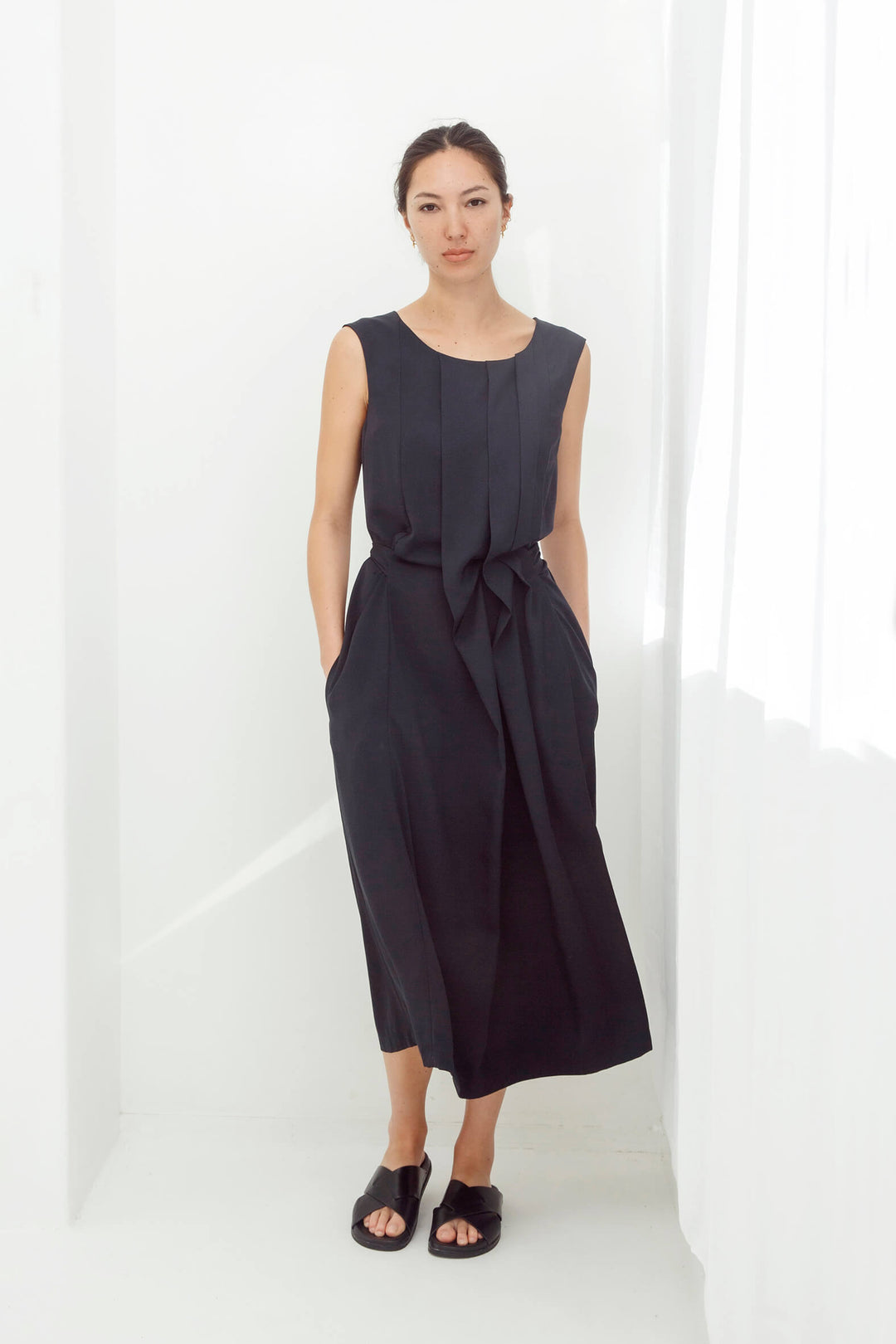 woman wearing a handmade navy pleated japanese maxi dress