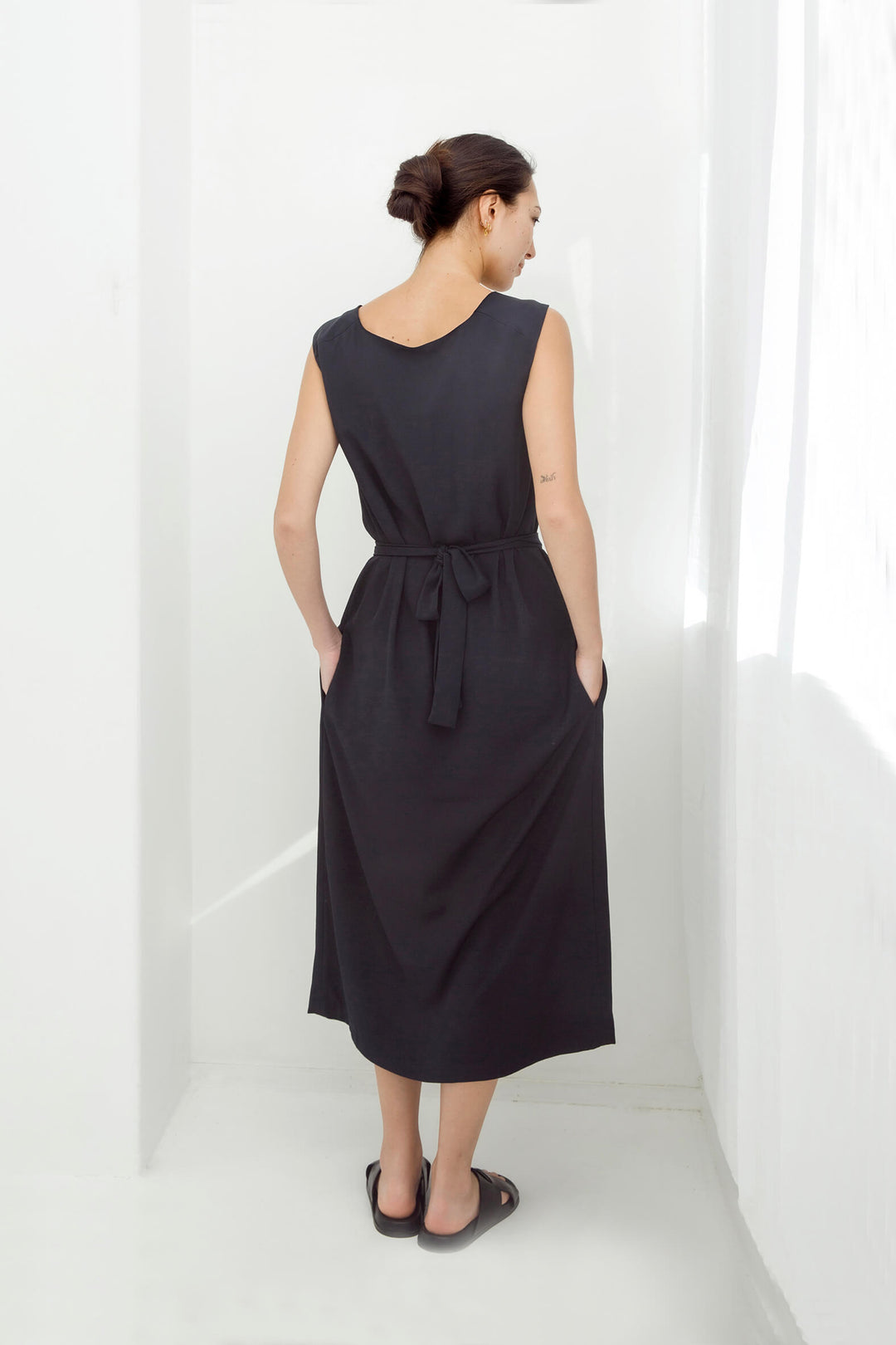 woman wearing a handmade navy pleated japanese maxi dress