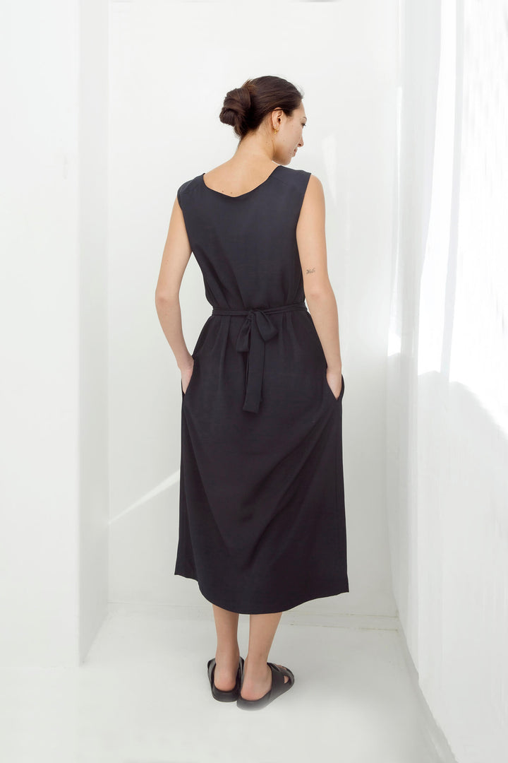 woman wearing a handmade navy pleated japanese maxi dress