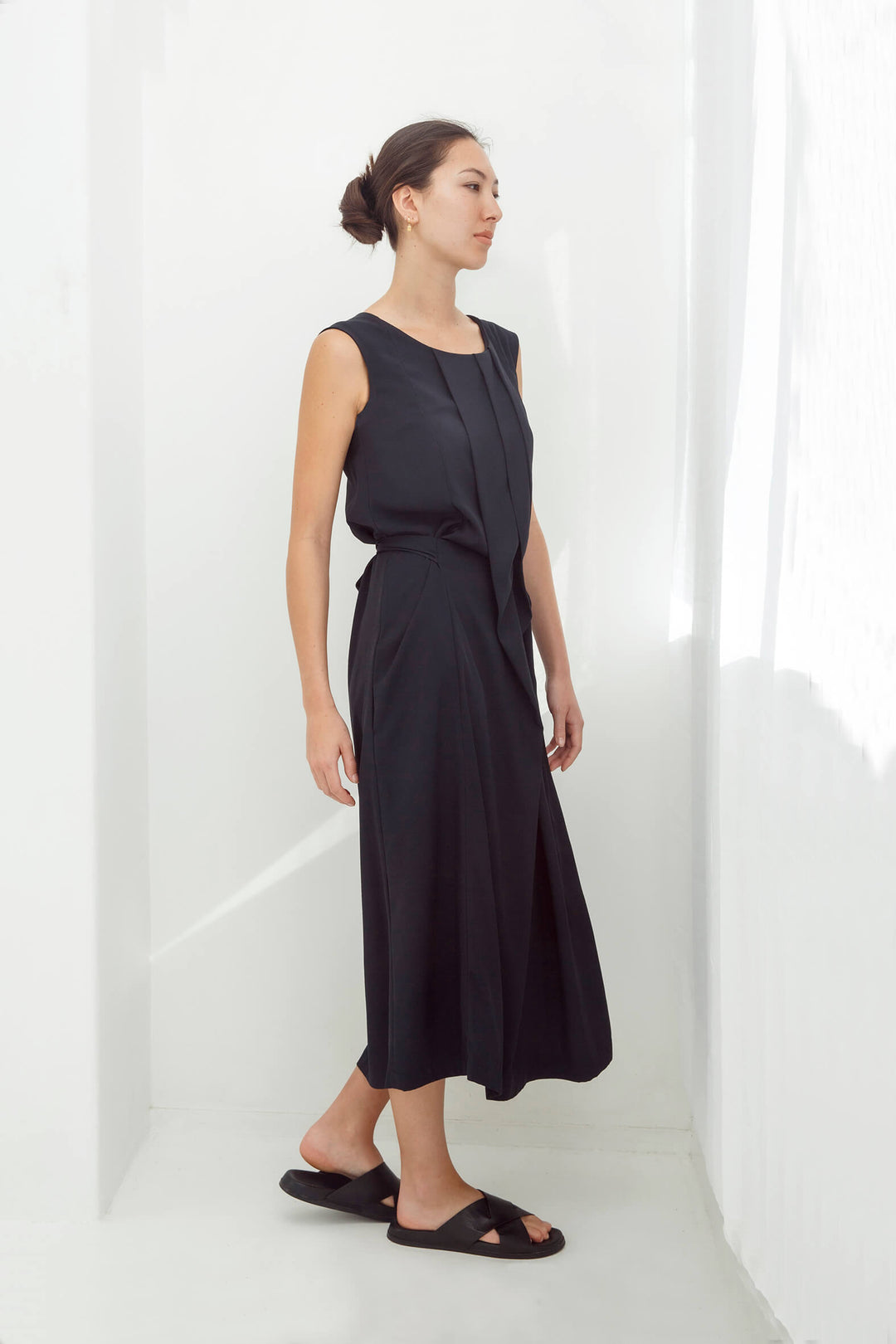 woman wearing a handmade navy pleated japanese maxi dress