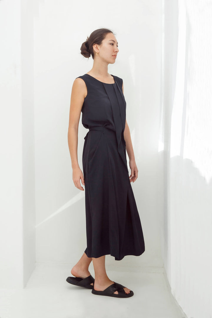 woman wearing a handmade navy pleated japanese maxi dress