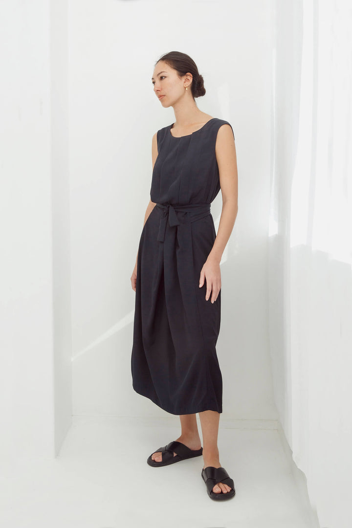 woman wearing a handmade navy pleated japanese maxi dress