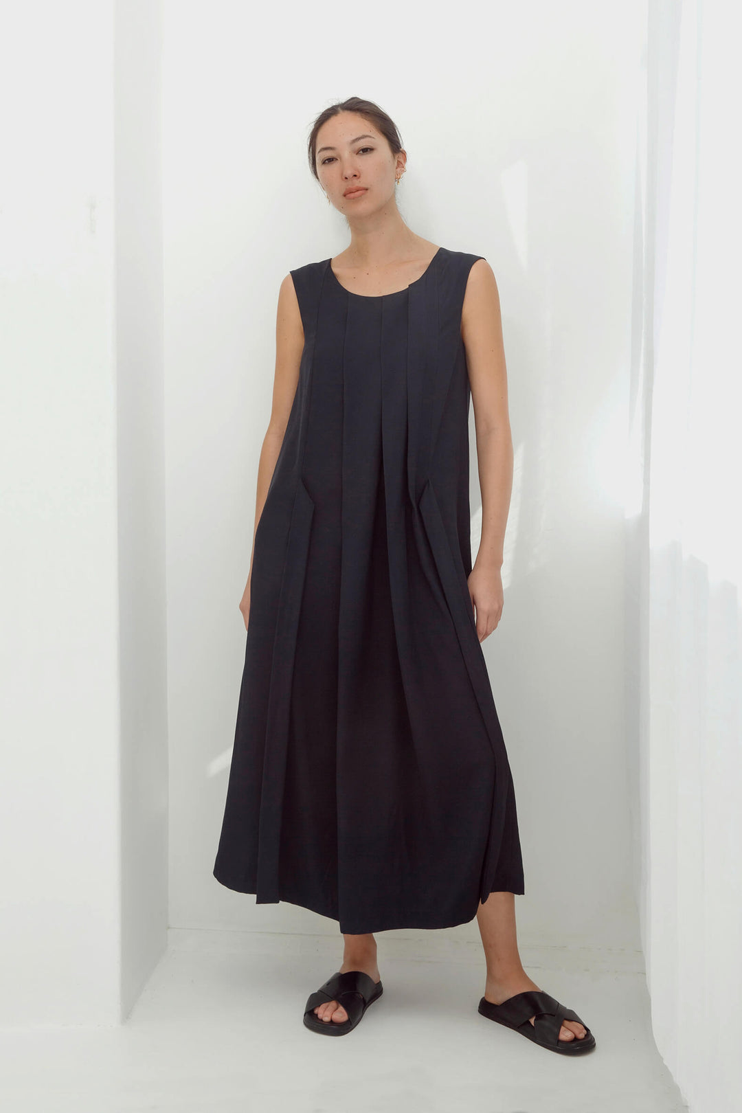 woman wearing a handmade navy pleated japanese maxi dress