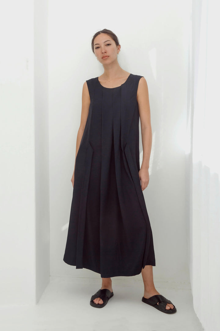 woman wearing a handmade navy pleated japanese maxi dress