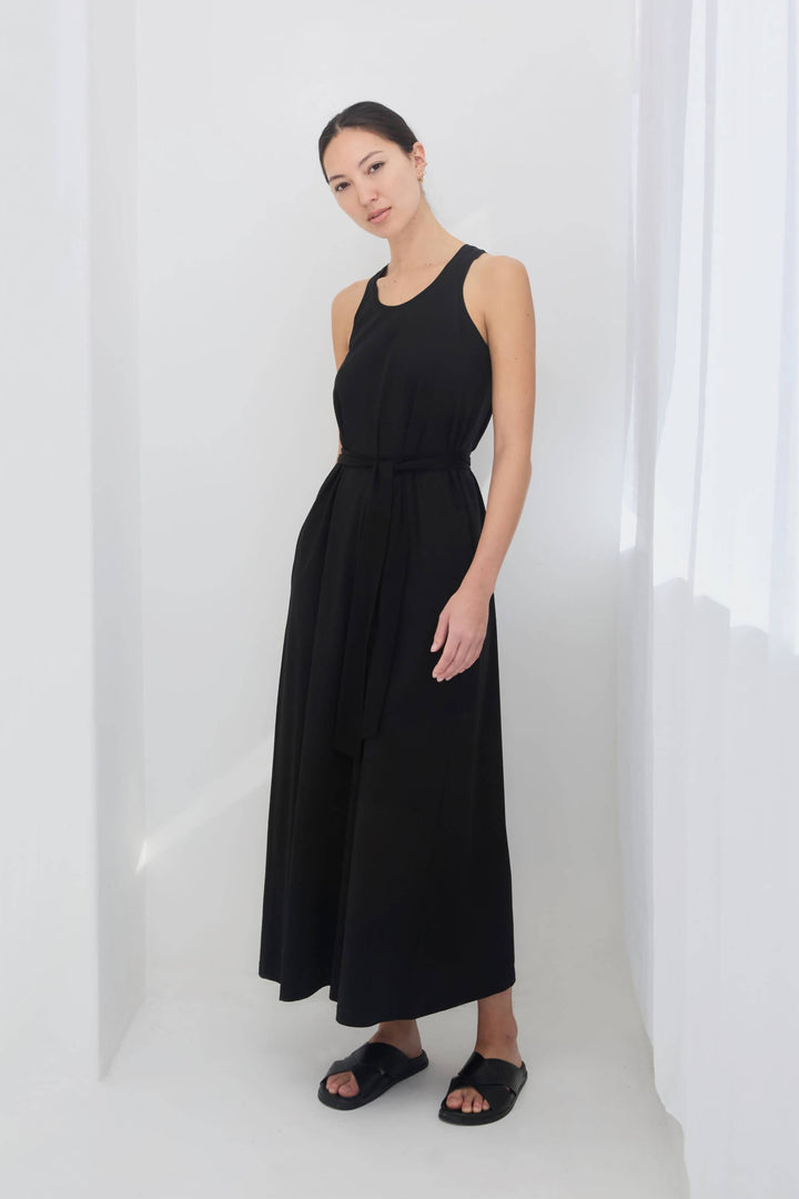 woman wearing a black sleeveless racer back singlet maxi dress