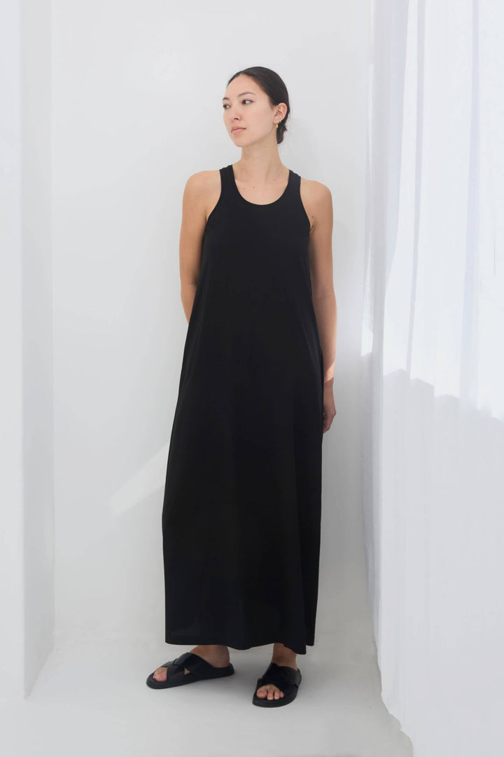woman wearing a black sleeveless racer back singlet maxi dress
