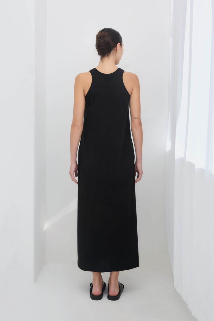 woman wearing a black sleeveless racer back singlet maxi dress