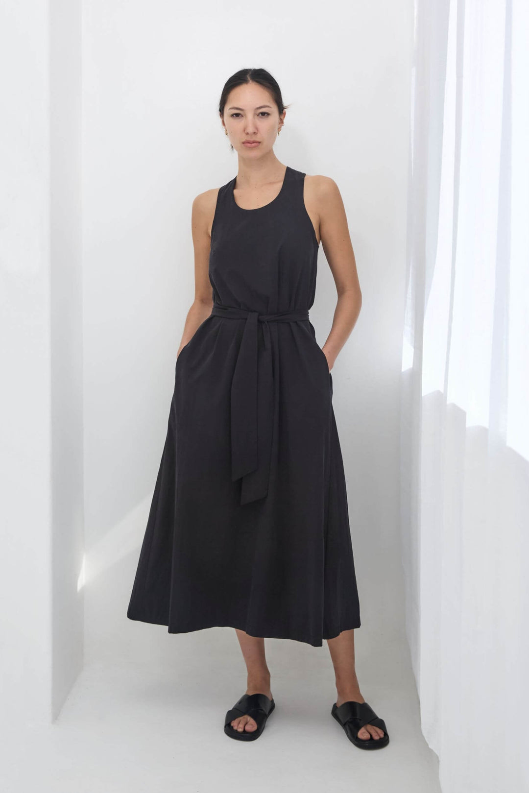 woman wearing a black, handmade, japanese, cross over strap, cotton maxi dress