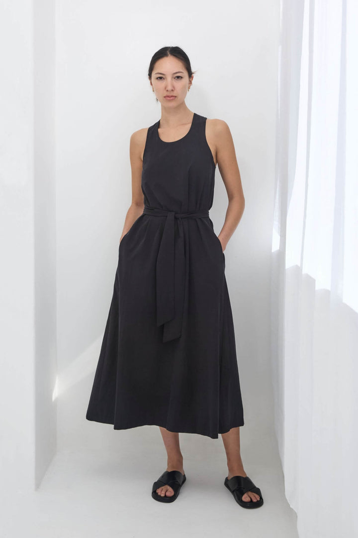 woman wearing a black, handmade, japanese, cross over strap, cotton maxi dress