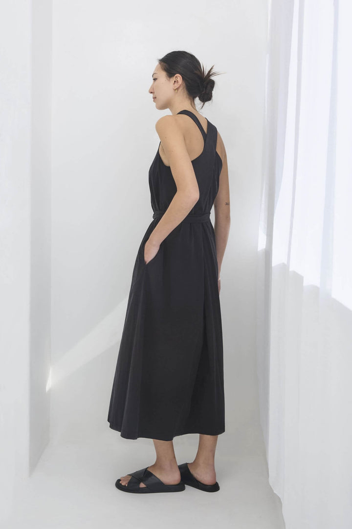 woman wearing a black, handmade, japanese, cross over strap, cotton maxi dress