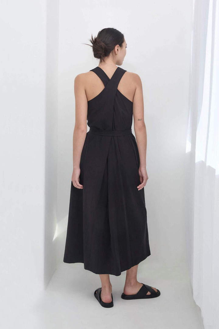 woman wearing a black, handmade, japanese, cross over strap, cotton maxi dress