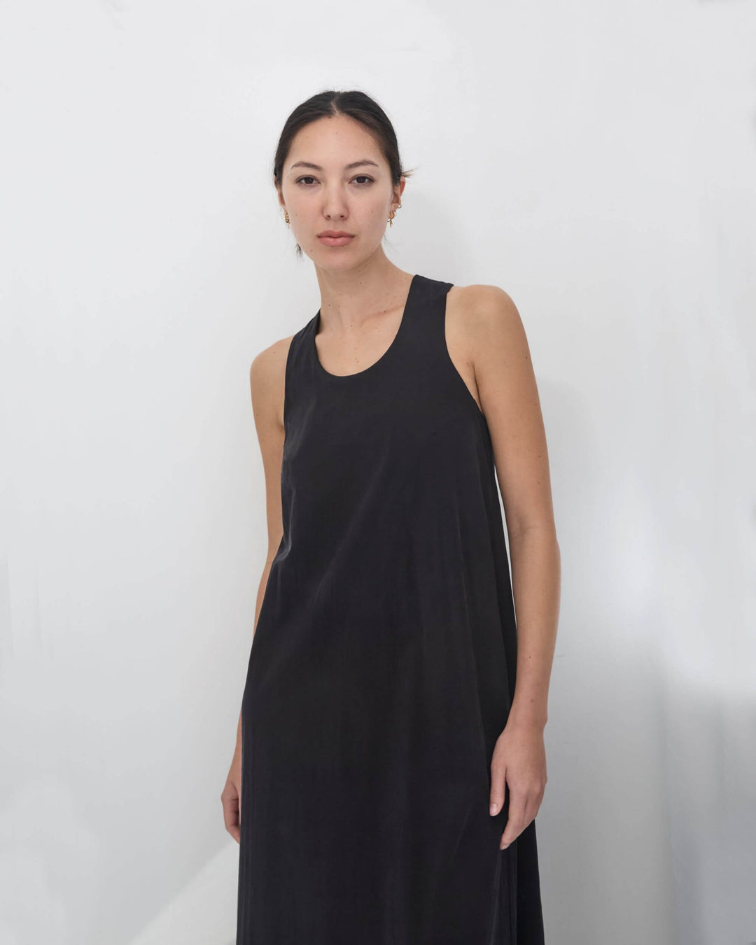 woman wearing a black, handmade, japanese, cross over strap, cotton maxi dress