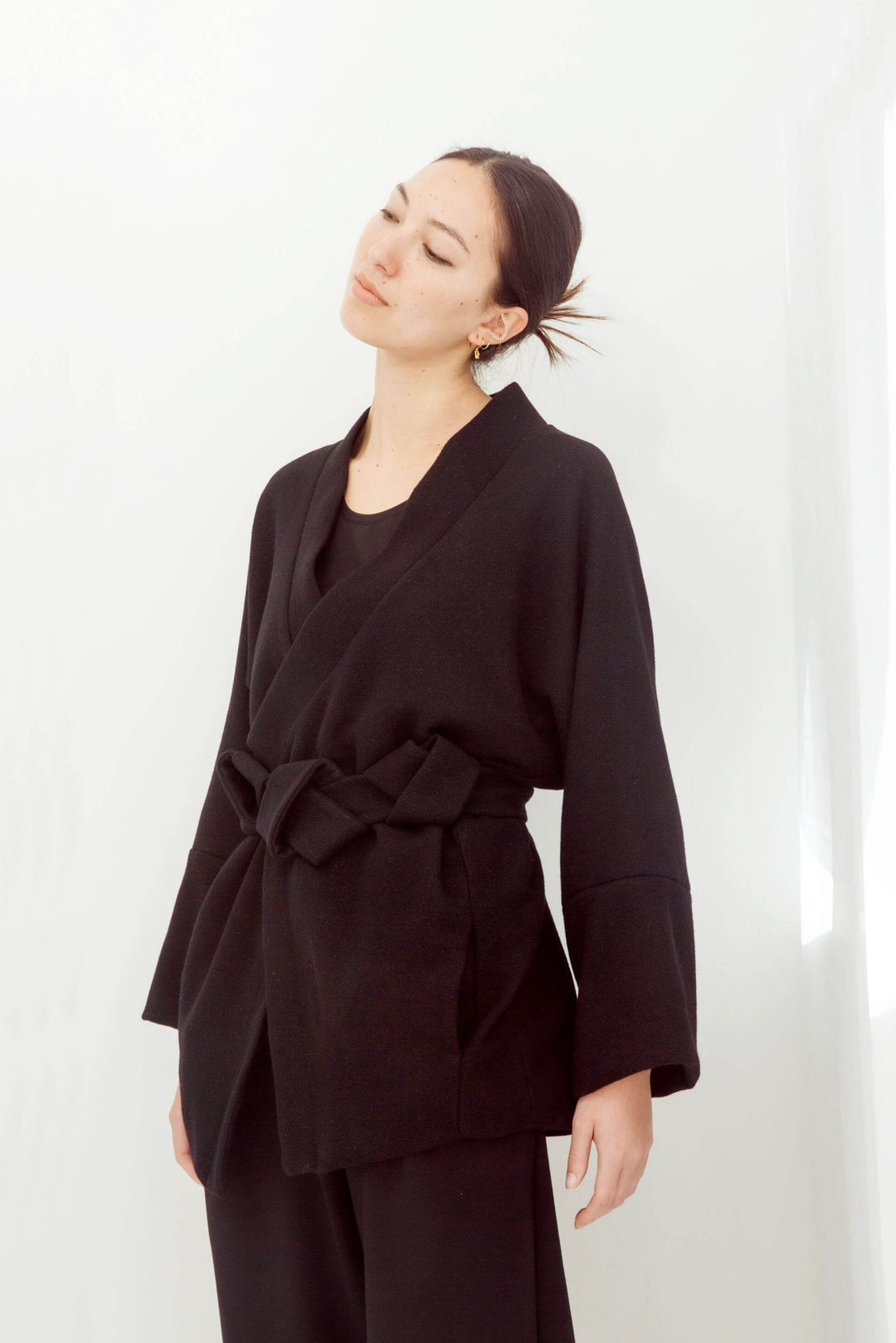woman wearing a handmade black kimono with obi belt