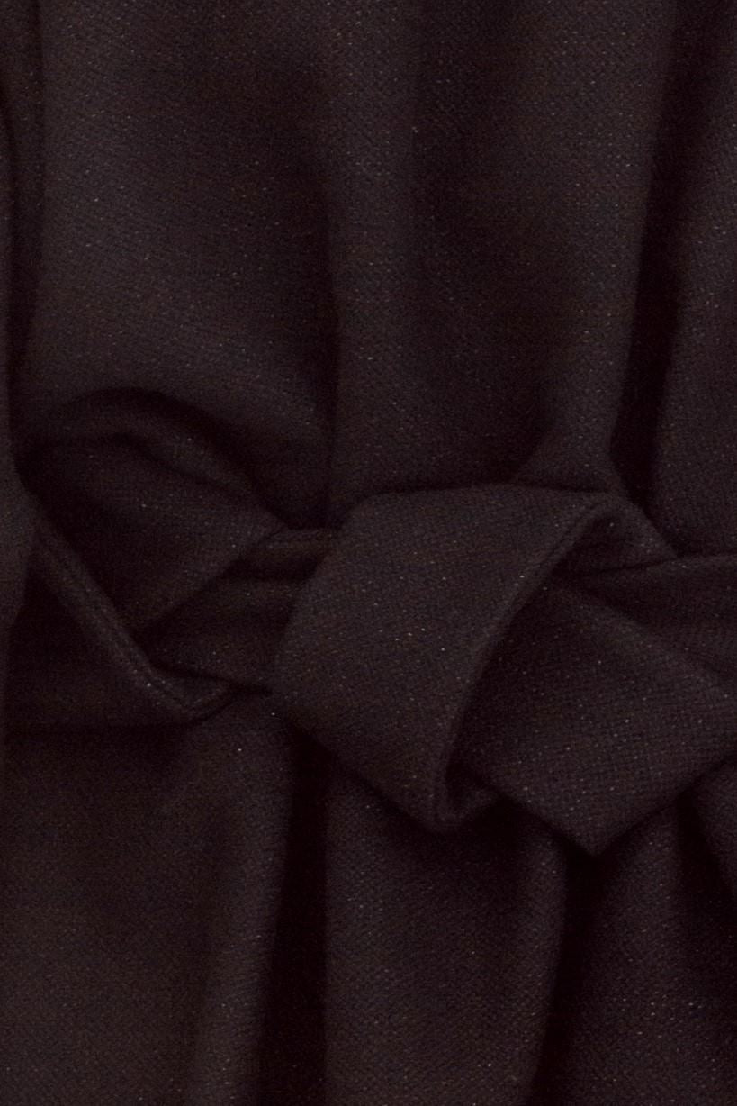 close up of black woollen jacket fabric